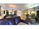 Inviting living area with a comfortable armchair, mirrored wall, and seamless flow into the dining space at 3400 Gulf Blvd # 304, Belleair Beach, FL 33786