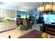 Open-concept living room featuring updated lighting and a large mirror wall with plenty of seating at 3400 Gulf Blvd # 304, Belleair Beach, FL 33786