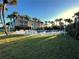 An inviting pool area with ample seating and landscaping beside the low-rise condo building at 3400 Gulf Blvd # 304, Belleair Beach, FL 33786