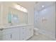 Modern bathroom with a double vanity, large mirror, and a spacious walk-in shower at 3409 E 11Th Ave, Tampa, FL 33605