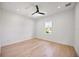 Clean bedroom with wood flooring, a modern ceiling fan, and a window with a view at 3601 W Platt St, Tampa, FL 33609