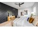 Modern bedroom with dark accent wall, a ceiling fan, and contemporary decor at 3601 W Platt St, Tampa, FL 33609