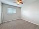 Bedroom featuring neutral colored carpet, a window with blinds and a ceiling fan with a light fixture at 37143 Janet Cir, Dade City, FL 33525