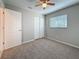 Bedroom featuring neutral colored carpet, a window with blinds and a closet with sliding doors at 37143 Janet Cir, Dade City, FL 33525