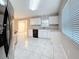 Bright kitchen featuring white cabinets, neutral countertops, and black appliances at 37143 Janet Cir, Dade City, FL 33525