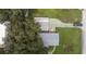 Aerial shot of the home with a detached garage and large driveway at 38055 Avion Dr, Zephyrhills, FL 33542
