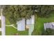 This aerial view features a home with a well-maintained roof and detached garage at 38055 Avion Dr, Zephyrhills, FL 33542