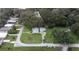 Home featuring a spacious lot, detached garage, and lush surrounding trees at 38055 Avion Dr, Zephyrhills, FL 33542