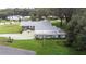 This aerial view showcases the home, detached garage, and patio area at 38055 Avion Dr, Zephyrhills, FL 33542