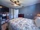 This bedroom features wood floors, a ceiling fan and neutral paint at 38055 Avion Dr, Zephyrhills, FL 33542