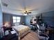 This bedroom features a ceiling fan, wood floors, and neutral paint at 38055 Avion Dr, Zephyrhills, FL 33542