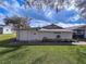 Side exterior view showcasing a simple white structure with a well-kept lawn at 38055 Avion Dr, Zephyrhills, FL 33542