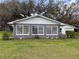 Home featuring three windows with white trim at 38055 Avion Dr, Zephyrhills, FL 33542