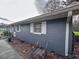 Painted home with white trim and view of the yard at 38055 Avion Dr, Zephyrhills, FL 33542
