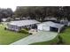 Features a home with a detached garage and patio area for outdoor enjoyment at 38055 Avion Dr, Zephyrhills, FL 33542
