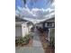 Walkway between houses highlighting landscaping and exterior features at 38055 Avion Dr, Zephyrhills, FL 33542
