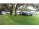Charming single-story home with large front yard and mature trees at 38055 Avion Dr, Zephyrhills, FL 33542