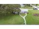 Captivating view of a cozy home with an expansive front yard and distinct walkway design at 38055 Avion Dr, Zephyrhills, FL 33542
