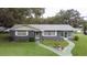 Charming single-story home with lush green lawn and walkway leading to the front entrance at 38055 Avion Dr, Zephyrhills, FL 33542