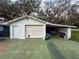 Attached garage with covered parking space and visible storage items at 38055 Avion Dr, Zephyrhills, FL 33542