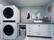 This laundry room features a modern washer/dryer and decorative tile at 38055 Avion Dr, Zephyrhills, FL 33542