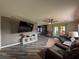 Open living room with TV and French Doors to the rear at 38055 Avion Dr, Zephyrhills, FL 33542