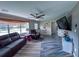 Cozy living room with wood-look tile floors, comfortable seating and a ceiling fan at 38055 Avion Dr, Zephyrhills, FL 33542