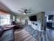 Open living room featuring wood-look tile flooring connecting to the kitchen area at 38055 Avion Dr, Zephyrhills, FL 33542