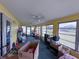 Bright sunroom with lots of windows, ceiling fans, and ample natural light, ready for personalization and relaxation at 38055 Avion Dr, Zephyrhills, FL 33542