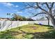 Back yard featuring a white fence, mature tree, and swing at 415 Maplewood Cir, Oldsmar, FL 34677
