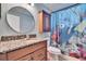 Updated bathroom with a decorative shower curtain, wood vanity and granite countertop at 415 Maplewood Cir, Oldsmar, FL 34677