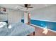 Large bedroom features half-painted walls, laminate floors, a ceiling fan and built-in closet at 415 Maplewood Cir, Oldsmar, FL 34677