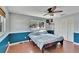 Bedroom features half-painted walls, laminate floors, a ceiling fan and built-in closet at 415 Maplewood Cir, Oldsmar, FL 34677