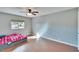 Simple bedroom with wood floors and a large window at 415 Maplewood Cir, Oldsmar, FL 34677