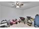 A bonus room with a ceiling fan and tiled floor featuring toy cars at 415 Maplewood Cir, Oldsmar, FL 34677
