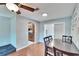 Well-lit dining area showcasing wood floors and direct access to the upgraded kitchen at 415 Maplewood Cir, Oldsmar, FL 34677