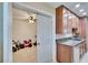 Spacious kitchen featuring granite counters, wood cabinets and a door leading to another room at 415 Maplewood Cir, Oldsmar, FL 34677