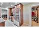 Well-lit kitchen with stainless steel appliances and dark wood cabinets, leading to a pantry and breakfast nook at 415 Maplewood Cir, Oldsmar, FL 34677