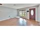 Bright living room with hardwood floors, large window, and front door at 415 Maplewood Cir, Oldsmar, FL 34677