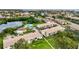 Aerial view of a condo community showcasing a pool, a pond and lush landscaping near the bay at 4570 Overlook Ne Dr # 282, St Petersburg, FL 33703