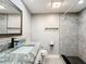 Bright bathroom featuring a granite countertop, modern sink and faucet, and a tiled walk-in shower at 4570 Overlook Ne Dr # 282, St Petersburg, FL 33703