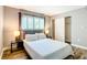 Comfortable bedroom featuring a plush bed, matching nightstands, modern lamps, and closet at 4570 Overlook Ne Dr # 282, St Petersburg, FL 33703
