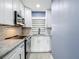 Modern kitchen with white cabinets, stainless steel appliances, and stylish backsplash at 4570 Overlook Ne Dr # 282, St Petersburg, FL 33703