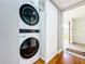 Modern stackable washer and dryer inside with adjacent storage and wood-look floors at 4570 Overlook Ne Dr # 282, St Petersburg, FL 33703