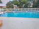 A pristine pool with chairs under shady trees offer a relaxing oasis at 4570 Overlook Ne Dr # 282, St Petersburg, FL 33703