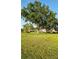 Large landscaped yard featuring mature trees in a serene, park-like setting at 4570 Overlook Ne Dr # 282, St Petersburg, FL 33703