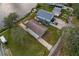 Aerial view of waterfront home with a spacious yard and driveway, situated near neighboring houses and the water at 4638 Heavens Way, New Port Richey, FL 34652