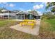 Backyard has a concrete patio and a bright yellow picnic table at 4638 Heavens Way, New Port Richey, FL 34652