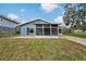 The home's backyard boasts a screened-in porch and a well-manicured lawn at 4638 Heavens Way, New Port Richey, FL 34652