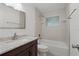 Bathroom featuring a shower-tub combo with marble-like tile and modern vanity at 4638 Heavens Way, New Port Richey, FL 34652